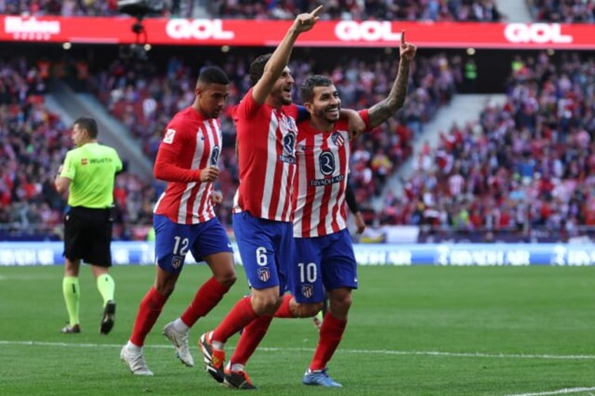 Atletico Madrid striker Angel Correa (R) celebrates scoring his team's fourth goal in the