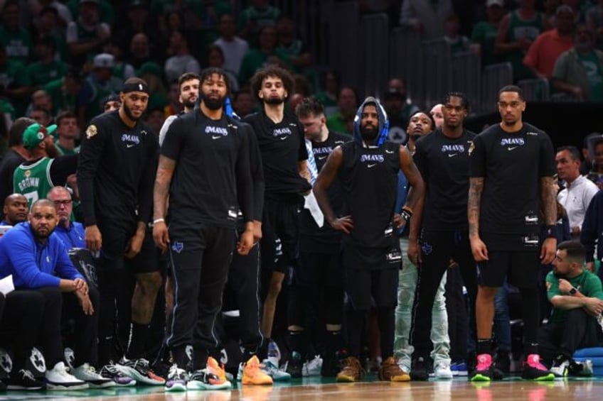 Kyrie Irving and Dallas Mavericks teammates watch from the bench in the final minutes of t