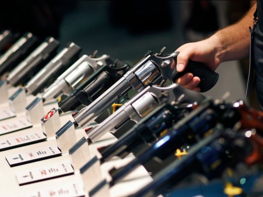 In this Jan. 19, 2016 file photo, handguns are displayed at the Smith & Wesson booth at th