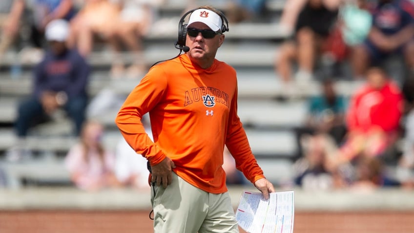 Hugh Freeze walks the sidelines