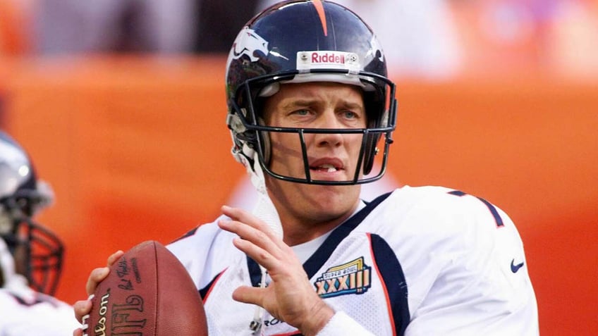 John Elway warms up