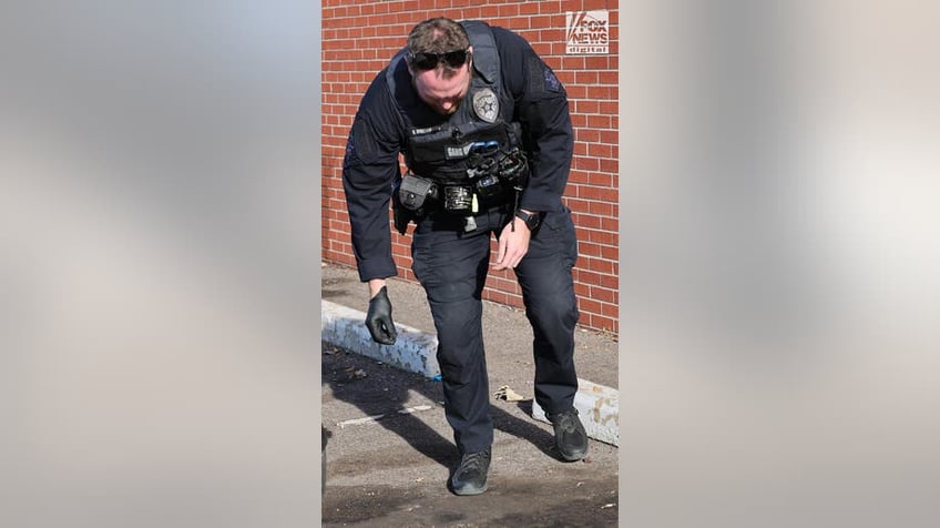 officer with shell casings