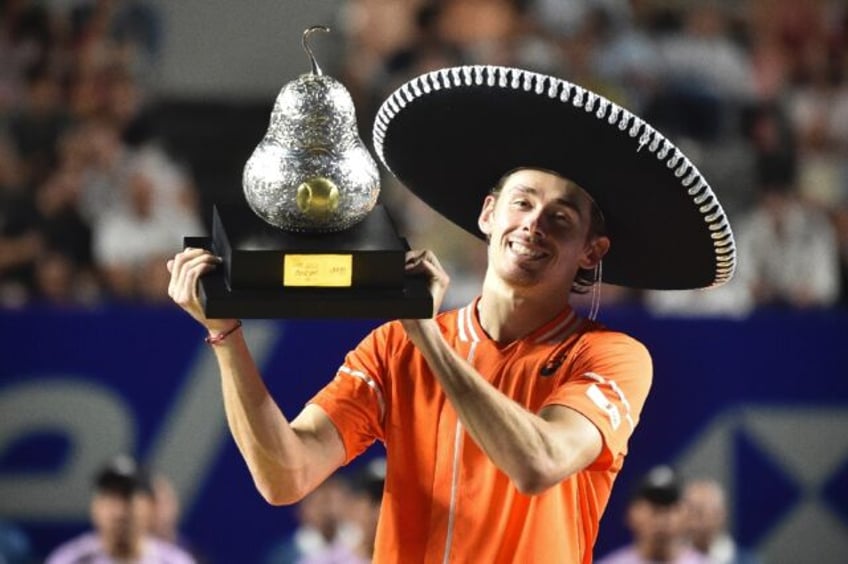 Australia's Alex de Minaur celebrates with his trophy after winning the ATP Mexico Open fi