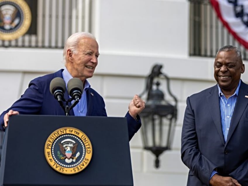 WASHINGTON, DC - JULY 04: President Joe Biden speaks as Secretary of Defense Lloyd Austin listens on the south lawn on July 04, 2023 in Washington, DC. The Bidens hosted a Fourth of July BBQ and concert with military families and other guests on the south lawn of the White …