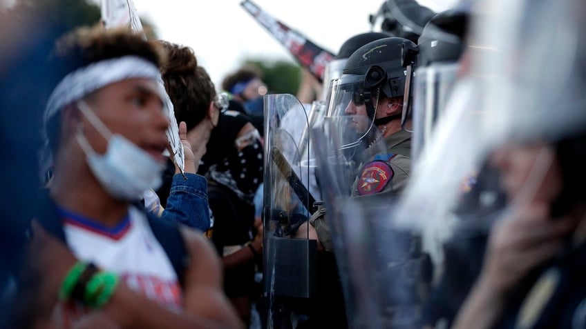 Protesters face off with Austin police officers