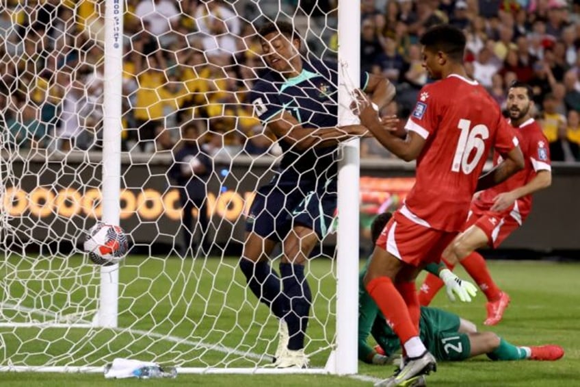 Kusini Yengi (left) bundles home Australia's first goal after two minutes against Lebanon