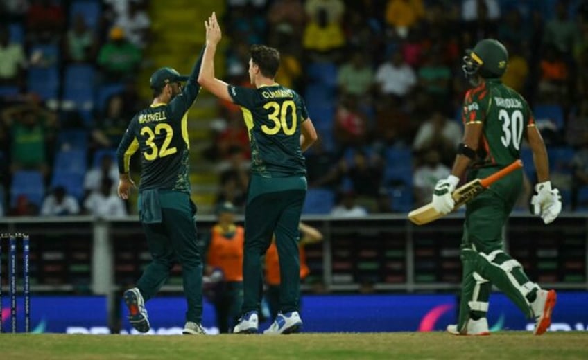 Australia's Pat Cummins celebrates after bowling out Bangladesh's Mahmudullah during Thurs