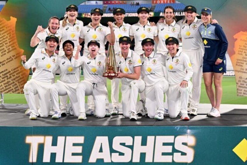 Australia players pose with the trophy after defeating England to complete an Ashes whitew