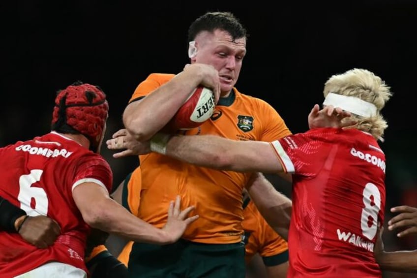 Australia prop Angus Bell is tackled by James Botham and Aaron Wainwright