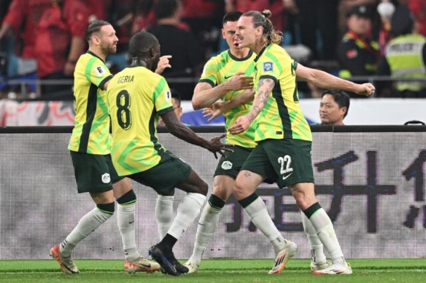 Australia's Jackson Irvine (right) celebrates with teammates after scoring against China i