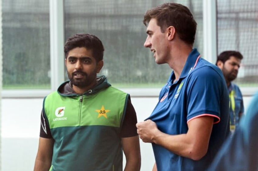 Australia captain Pat Cummins (R) chats with Pakistan batsman Babar Azam at the Melbourne Cricket Ground