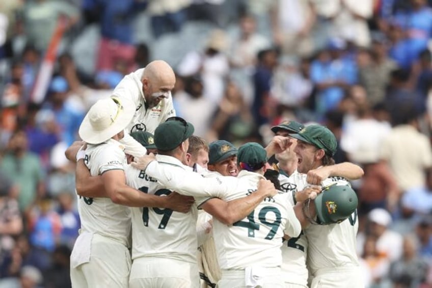 Australia players celebrate winning the fourth Test against India in Melbourne