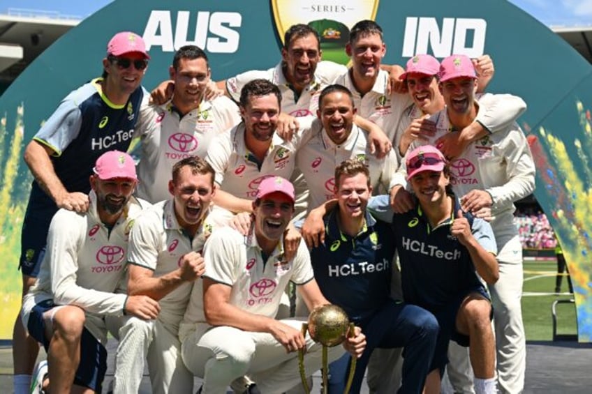 Australia players celebrate with the Border–Gavaskar Trophy after winning the fifth Test