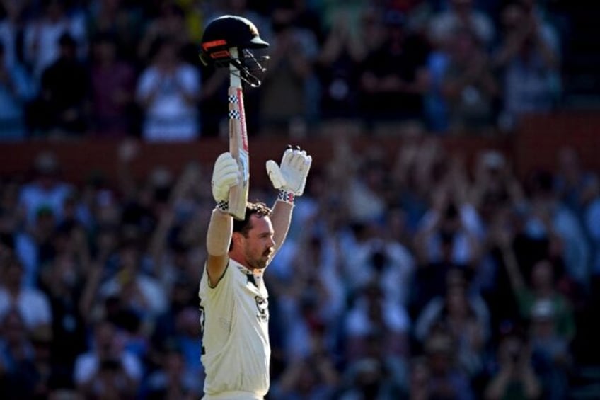 Australia's Travis Head celebrates after scoring a century on the second day of the second