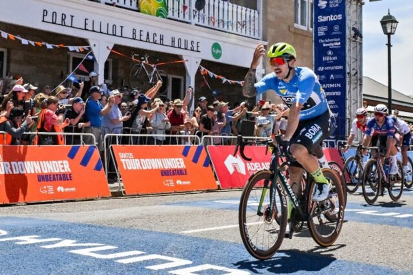 Sam Welsford celebrates as he crosses the finish line Friday