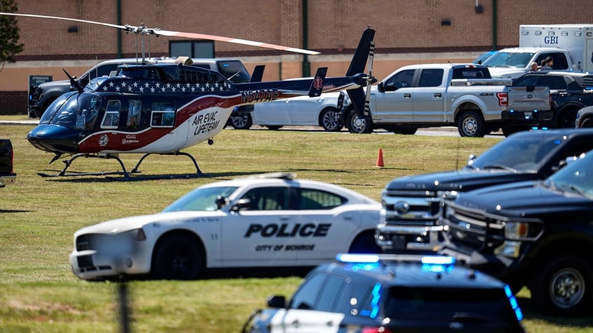 Police gather outside Apalachee High School after a shooting at the school