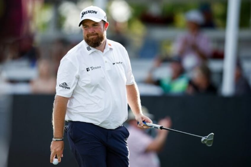 Ireland's Shane Lowry reacts to his birdie at the 17th on the way to the first-round lead