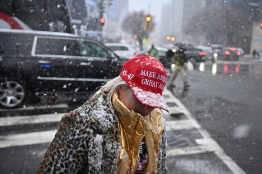 Snow fell as thousands remained in line to see US President-elect Donald Trump speak at vi