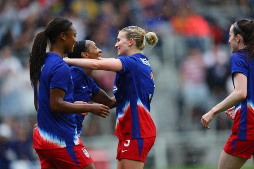 USA women's national team players celebrate after Crystal Dunn's opening goal in a 3-0 fri