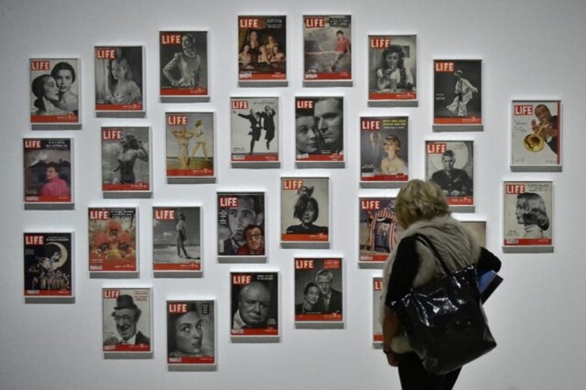 A woman looks at LIFE magazine copies as part of the show "Sorprendeme!", a retrospective