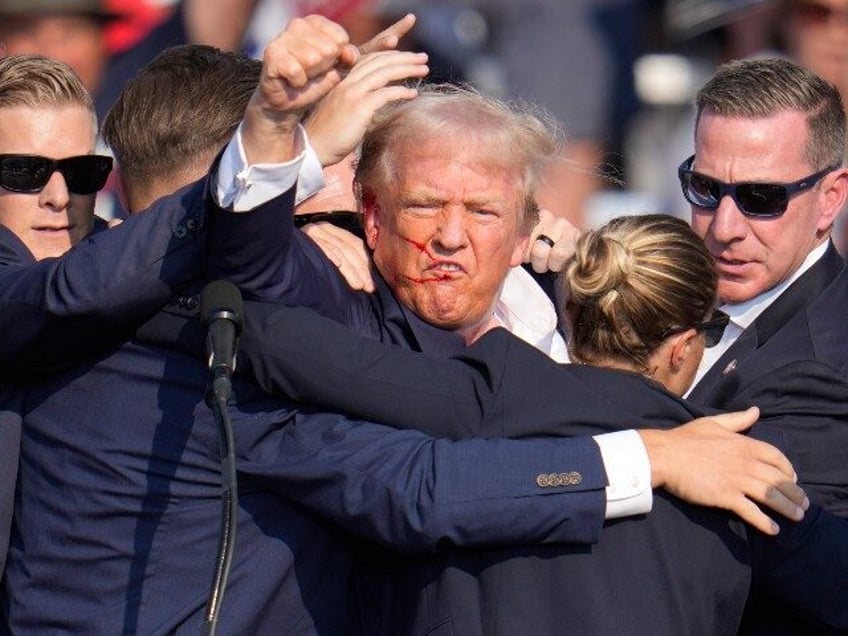 Republican presidential candidate former President Donald Trump is helped off the stage at