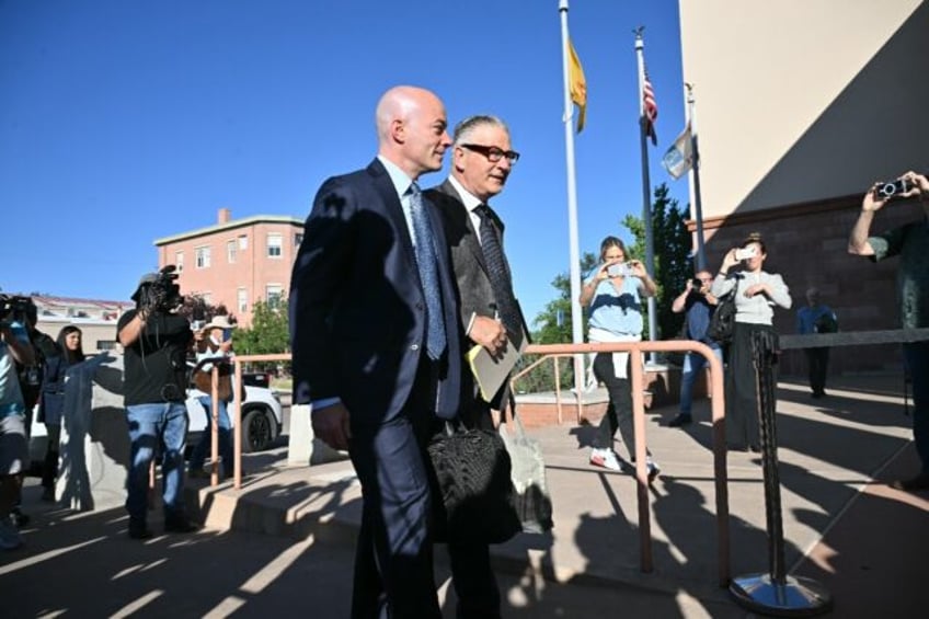 Alec Baldwin, accompanied by his lawyer, shot a glare at journalists before marching wordl