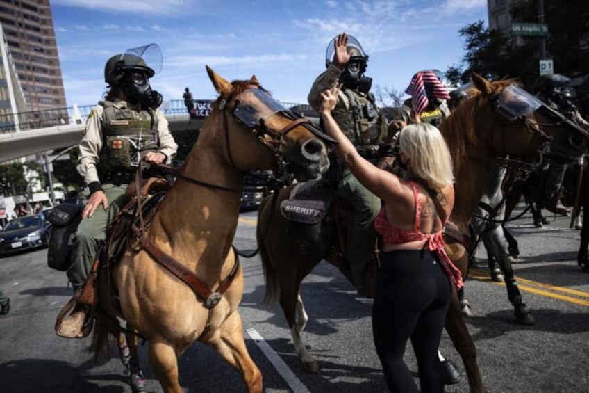 Mounted police moved in to disperse protesters gathered to demonstrate against the Trump a