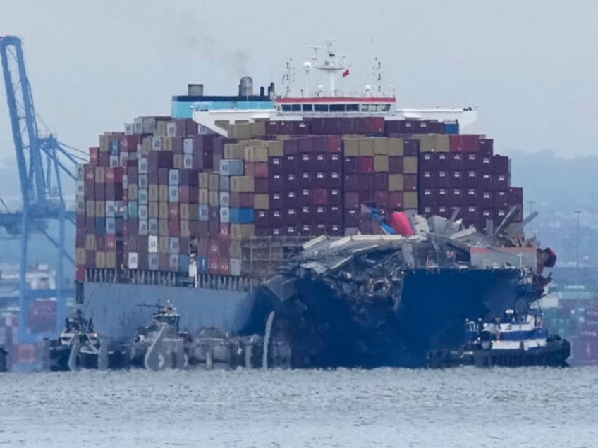 Crews work to move the cargo ship Dali in Baltimore, Monday, May 20, 2024. The vessel on M