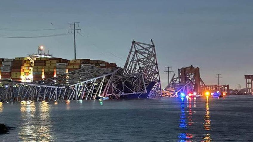 Baltimore bridge collapsed in the background as emergency vehicles are seen in the foreground
