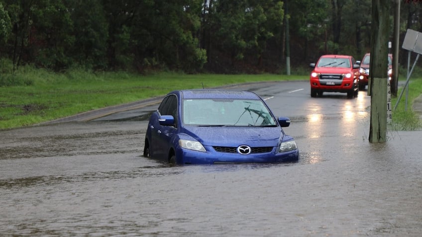 Car flooded in street