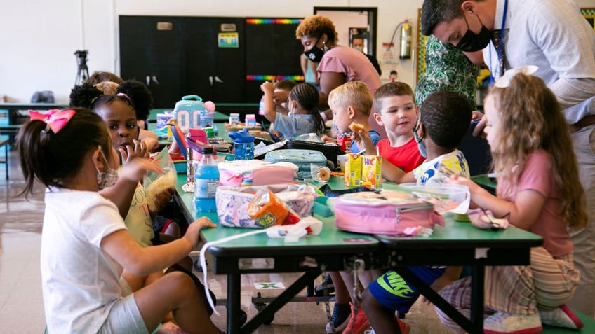 Students eat lunch on the first day of school at Wilder Elementary School in Louisville, Kentucky.