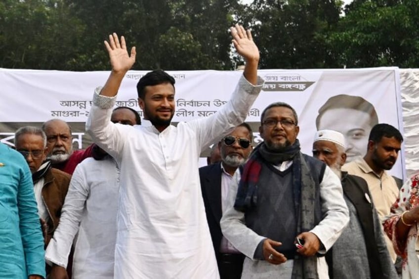 Colourful Bangladeshi cricketer Shakib Al Hasan (C) is all but guaranteed to become a ruling party lawmaker with general elections on Sunday boycotted by the opposition