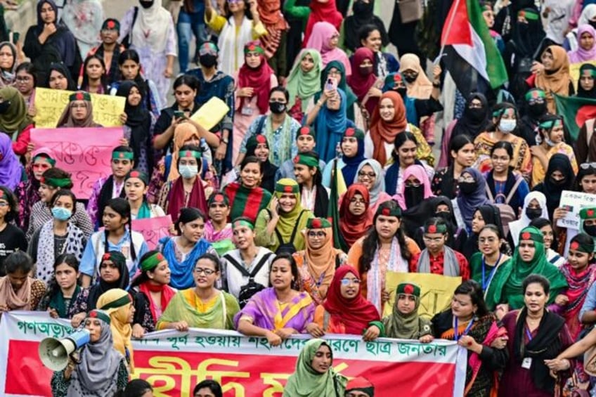 Bangladeshi demonstrators take part in a 'Martyr March' in Dhaka to mark one month since t