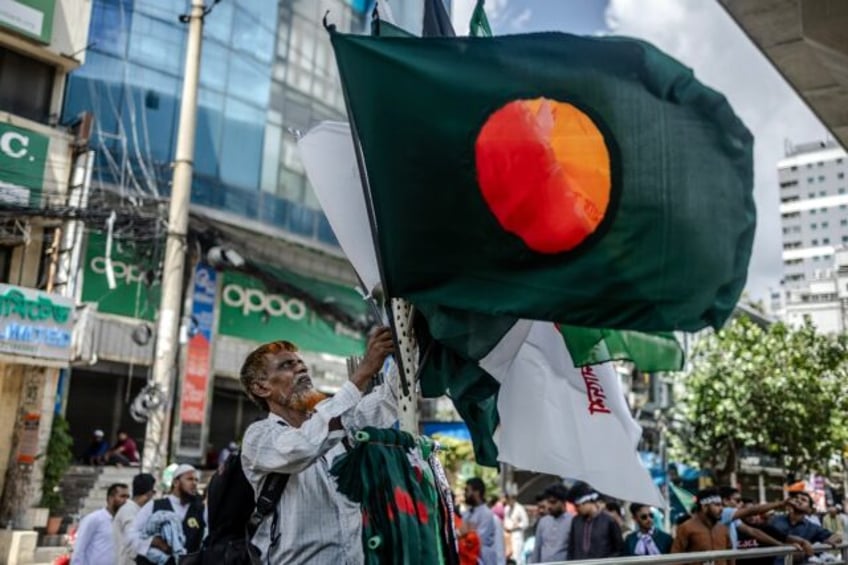 A man sells Bangladesh's national flag in Dhaka on August 9, days after the ouster of auto