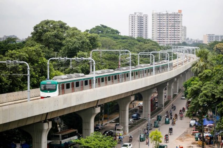 A metro train rides along a transit line in Dhaka; the Bangladeshi capital is one of the w