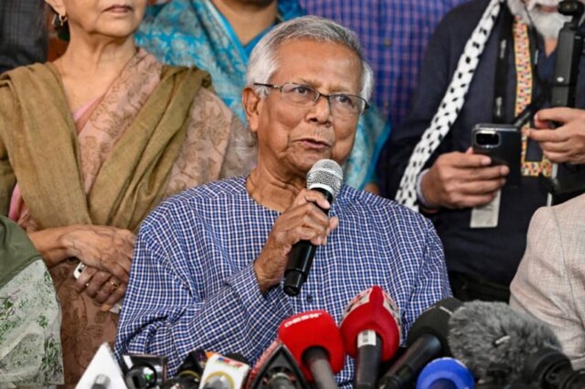 Bangladesh Nobel peace laureate Muhammad Yunus (C) says several of his companies were 'for