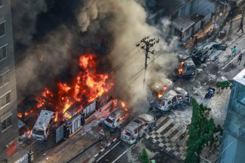 Smoke rises from burning vehicles near Bangladesh's disaster management agency on Thursday