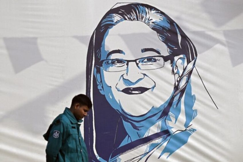 A policeman walks past a portrait of Bangladesh's Prime Minister Sheikh Hasina on Monday, a day after she won re-election for a fifth term