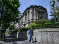 Bank of Japan holds rates, says to slow bond purchase taper