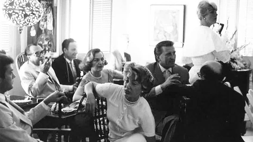 Kirk Douglas, Tony Curtis and Doris Day in a room with other guests at the wedding.