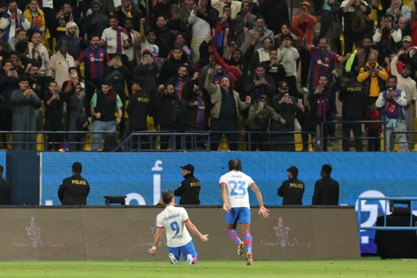 Barcelona striker Robert Lewandowski celebrates scoring his team's opening goal during the Spanish Super Cup semi-final against Osasuna