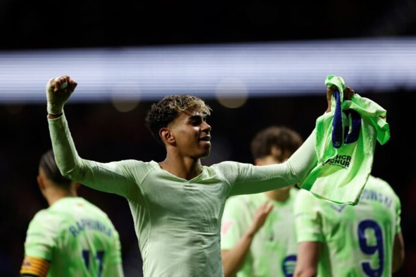 Barcelona's Spanish forward Lamine Yamal celebrates scoring his team's third goal in the w