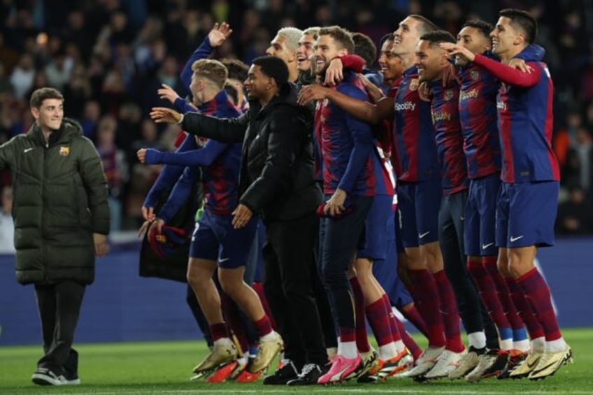 Barcelona players celebrate clinching a Champions League quarter-final spot in midweek