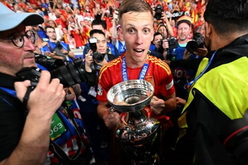 Spain forward Dani Olmo holds the trophy during a lap of honour after winning the Euro 202