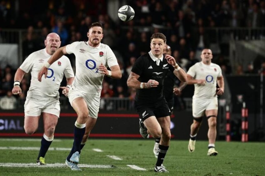 New Zealand's Beauden Barrett kicks past England's Freddie Steward