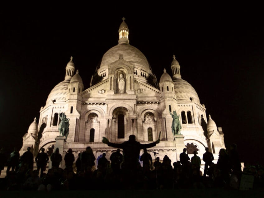 People listen to music in front of the Sacre Coeur basilica on October 14, 2010 at night i