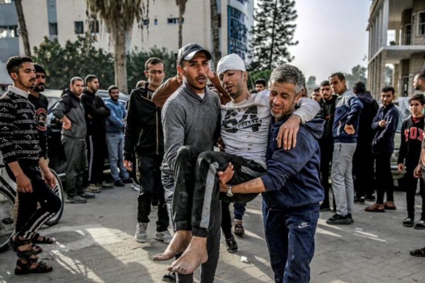 An injured man is helped outside Ahli Arab Hospital in Gaza City -- the United Nations say