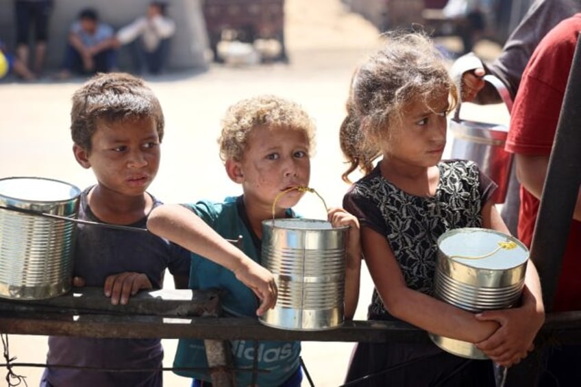 Displaced children wait for food being distributed in Khan Yunis, southern Gaza -- the Wor