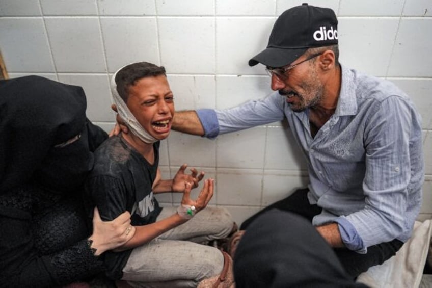An injured boy mourning the loss of his father in a strike on central Gaza's Maghazi refug