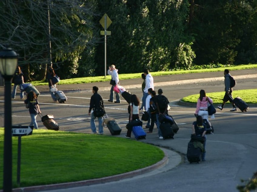 People walking in the street with suitcases